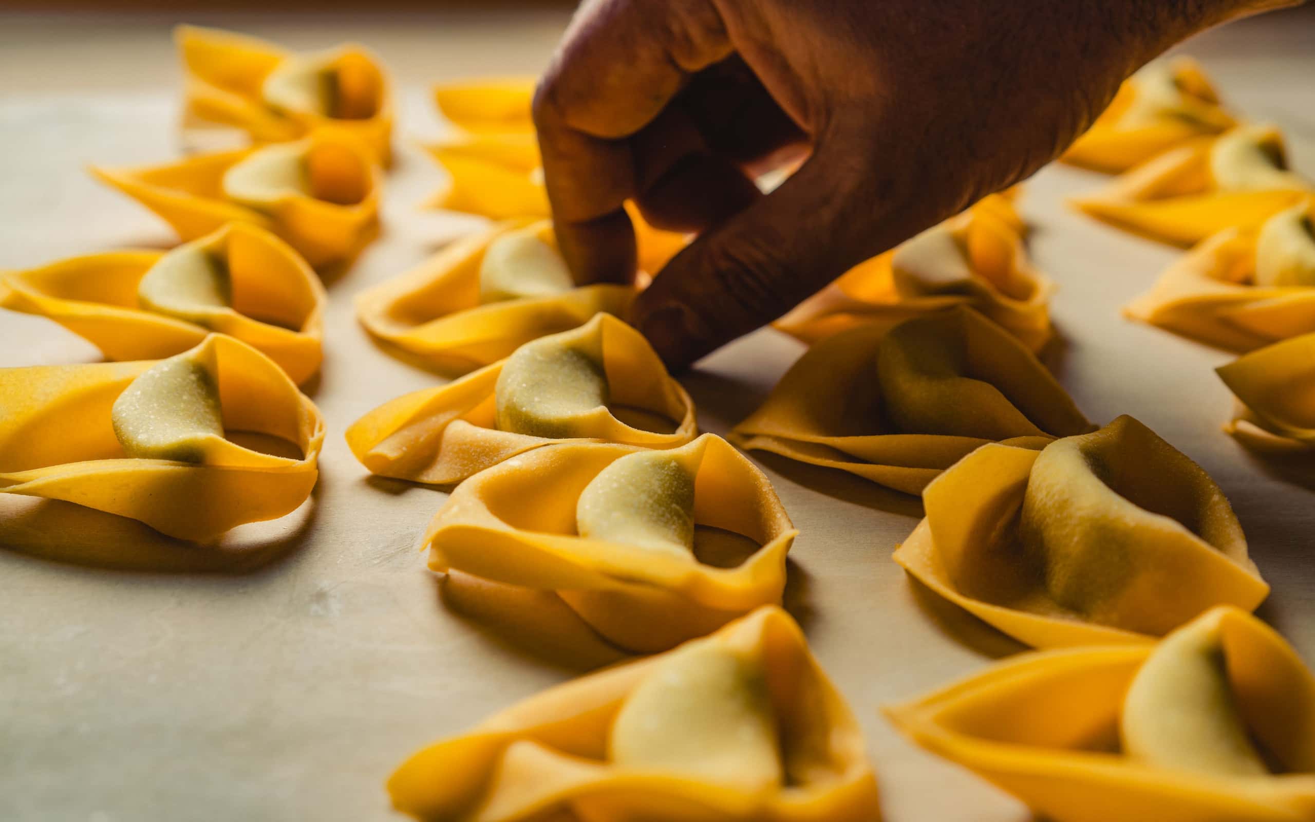 Small filled pasta pieces laid out on a countertop