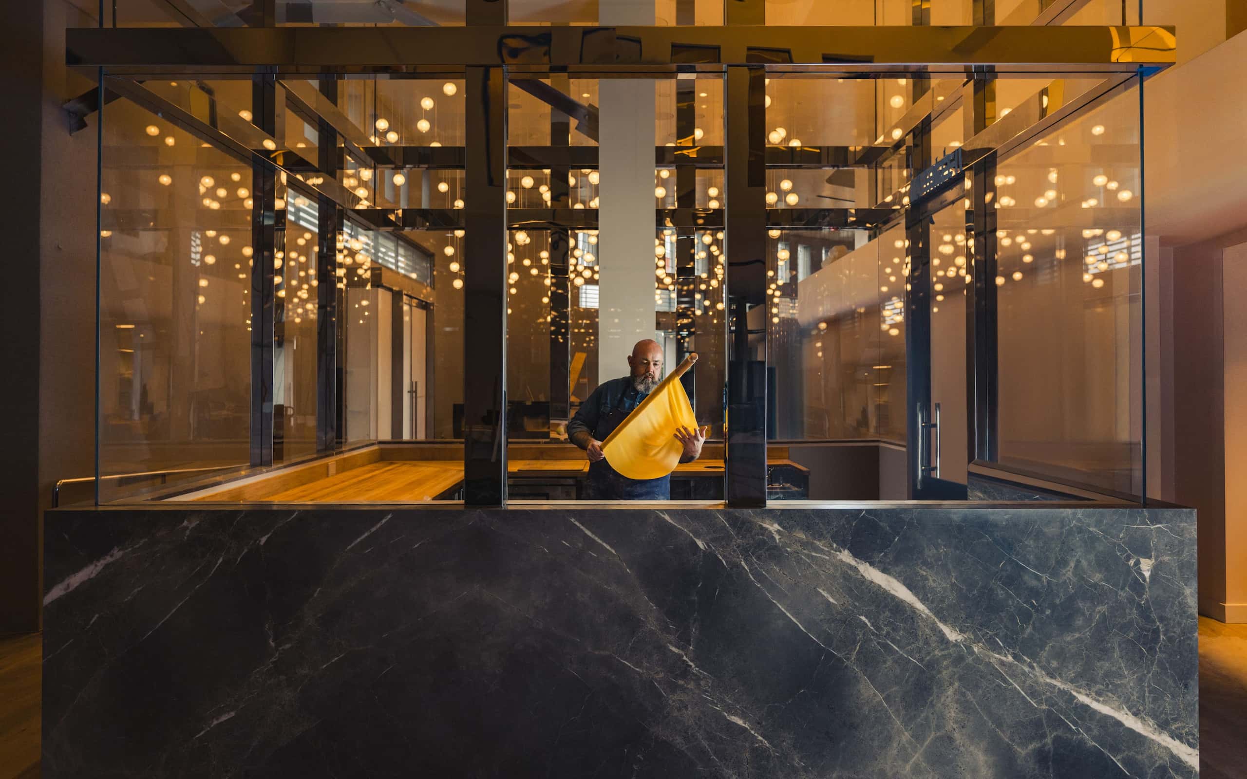 Evan Funke making pasta in a luxurious kitchen interior